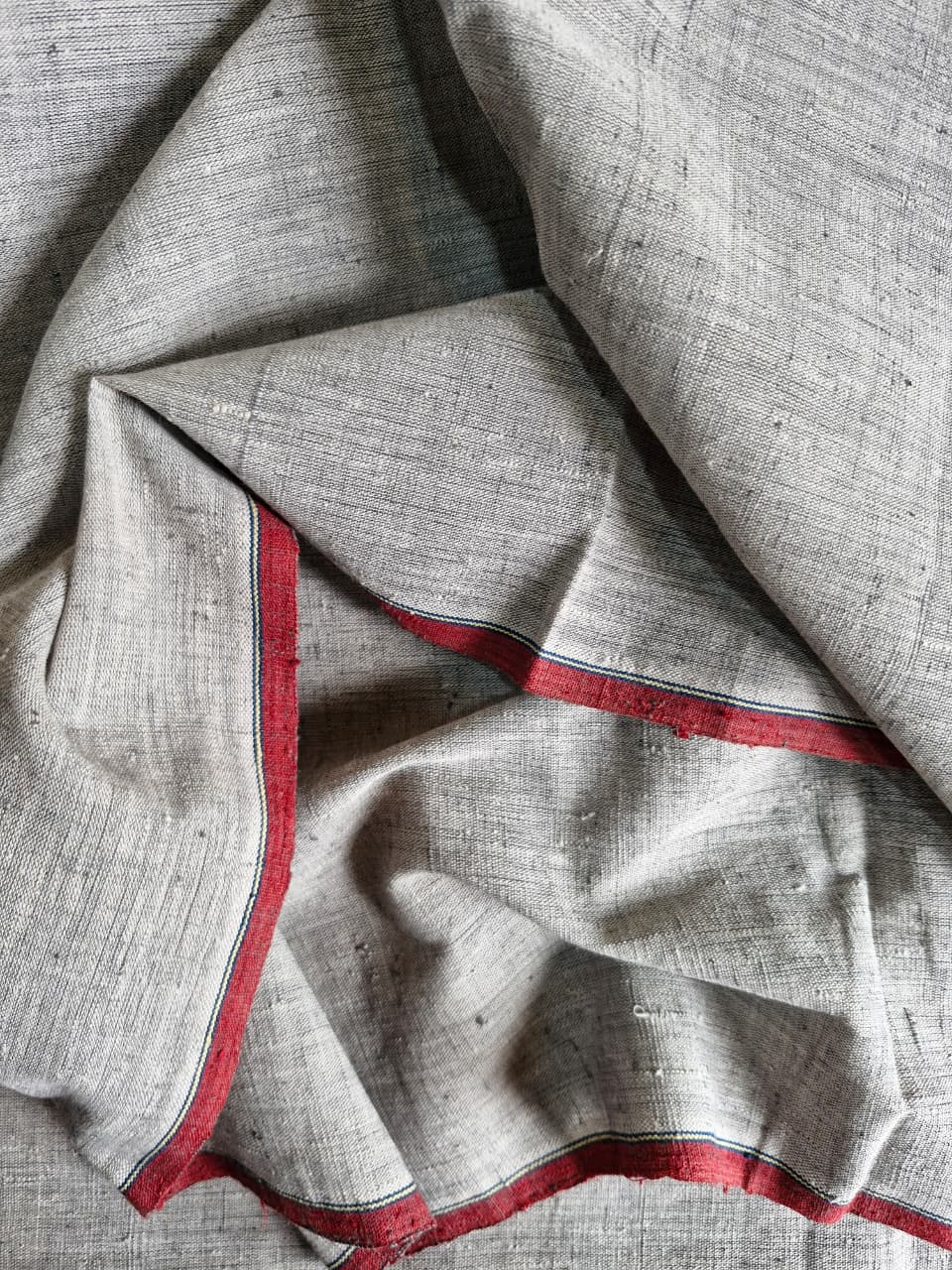 Gray fabric with red border