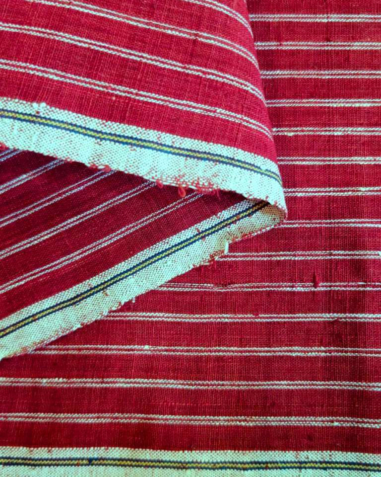 Close-up of red and white striped fabric with a focus on texture and pattern.