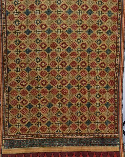 A vintage patterned textile or rug featuring a repeating diamond motif in red, green, and beige, with a decorative border at the bottom.