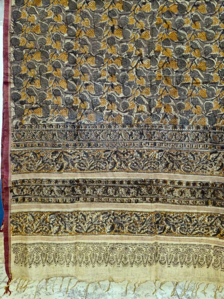 Decorative fabric with intricate patterns in black, gold, and white.