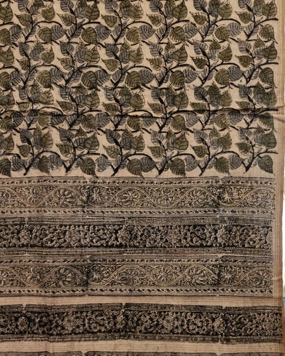 A close-up of a patterned textile or fabric panel with a beige base and dark charcoal/black leafy motifs, plus decorative horizontal bands with floral and geometric motifs.