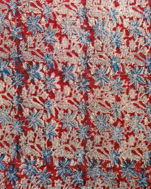 Floral patterned fabric with red, blue, and beige colors.