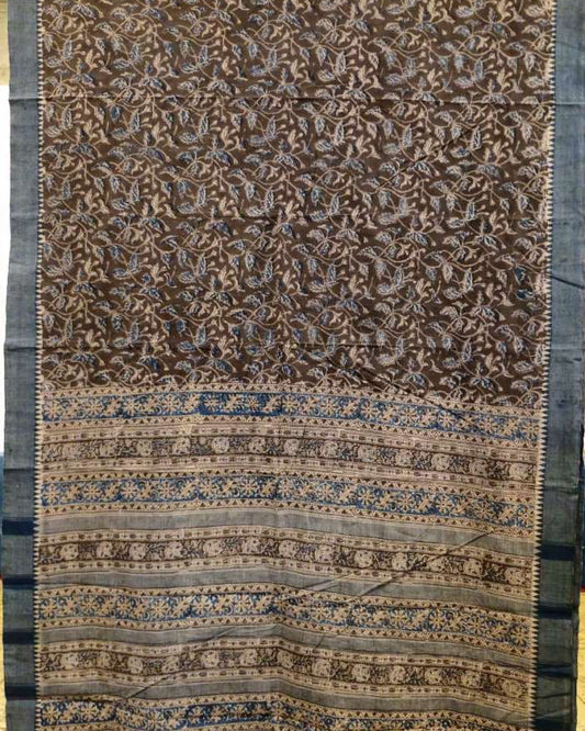 Decorative fabric with intricate patterns in brown and blue on a plain background