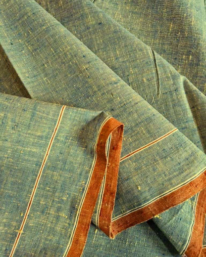 A close-up of draped fabric with a textured slate blue-gray base, accented by thin orange stripes and a wide rust-orange border.