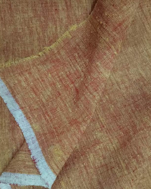 Close-up of brown fabric with a visible seam