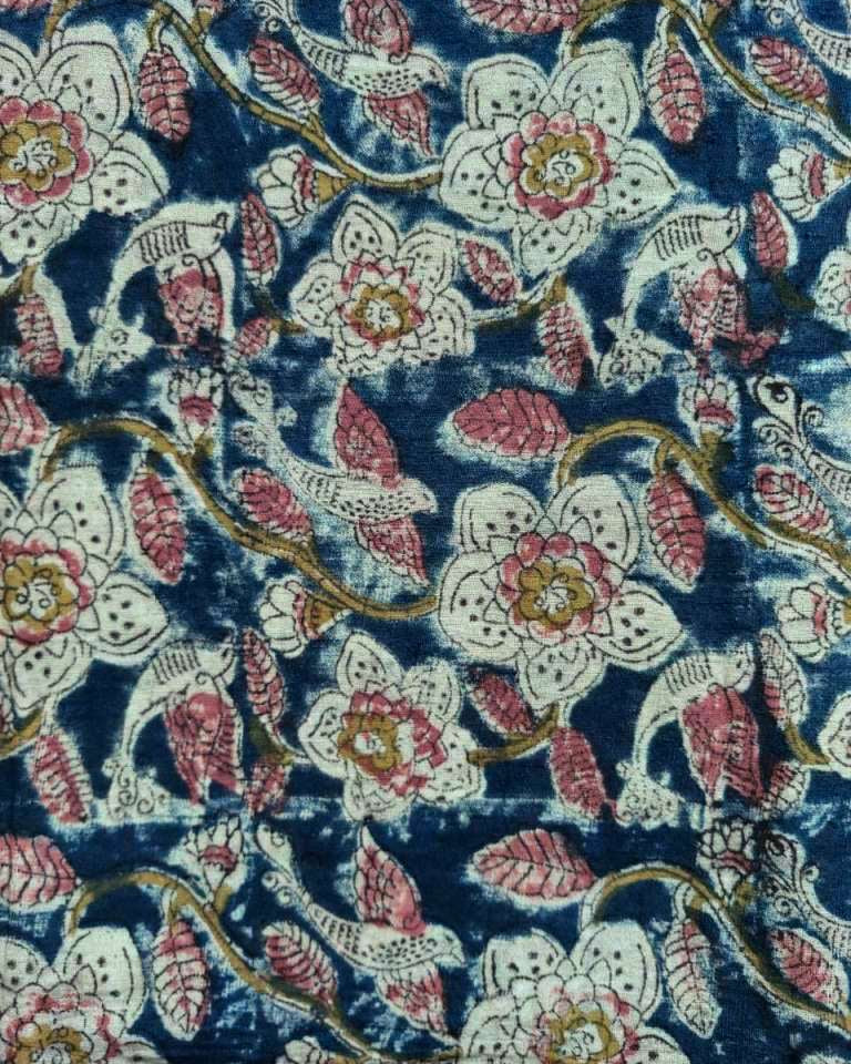 Floral patterned fabric with pink, white, and gold flowers on a blue background