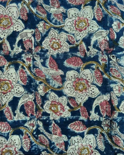 Floral patterned fabric with pink, white, and gold flowers on a blue background